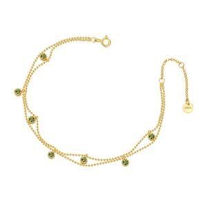 gold bracelet with green gemstones