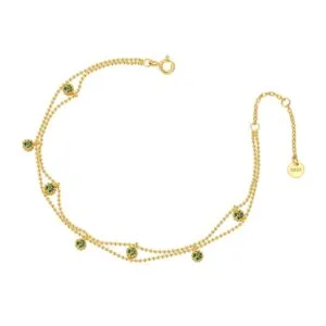 gold bracelet with green gemstones
