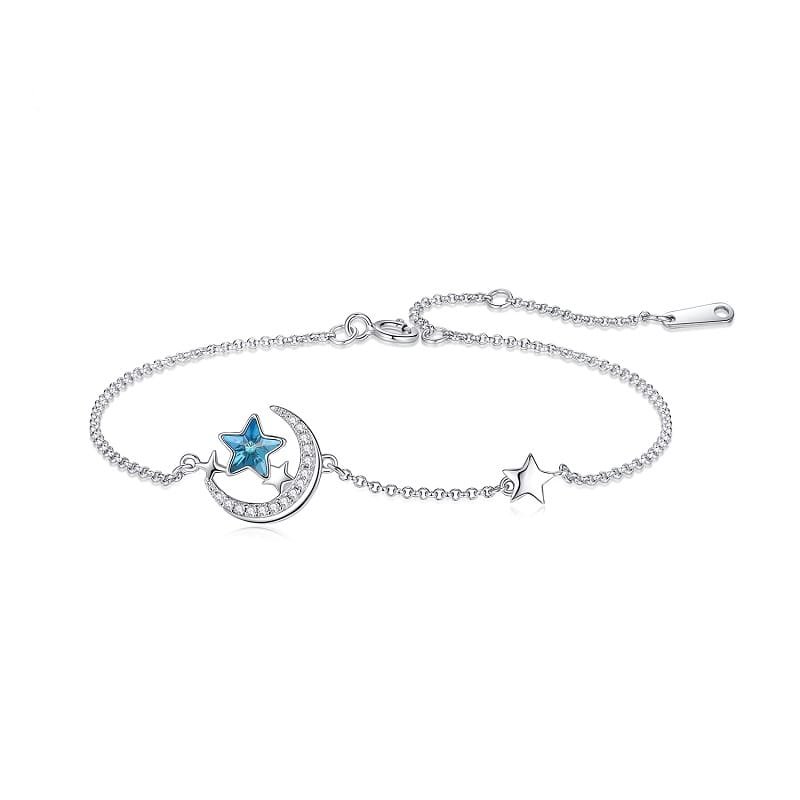 silver moon and star bracelet with blue gem
